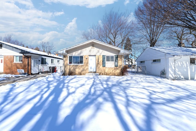 bungalow featuring brick siding