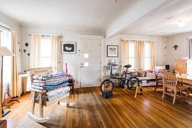 foyer with wood-type flooring and ornamental molding