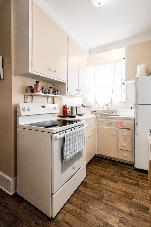 kitchen featuring white appliances, dark wood-style flooring, light countertops, white cabinetry, and a sink