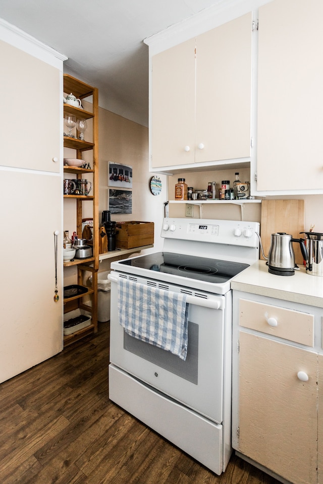 kitchen featuring light countertops, dark wood-style flooring, white electric range oven, and white cabinets