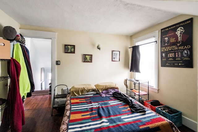 bedroom featuring a textured ceiling and wood finished floors