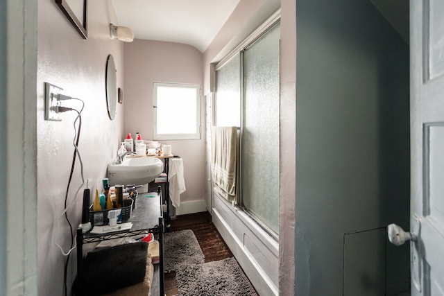 full bathroom featuring enclosed tub / shower combo, vanity, baseboards, and wood finished floors