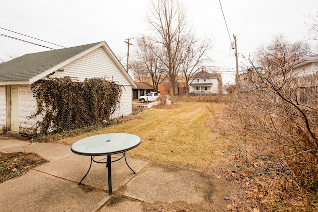 view of yard with fence and an outdoor structure