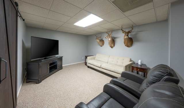 carpeted living area featuring a paneled ceiling, visible vents, and baseboards