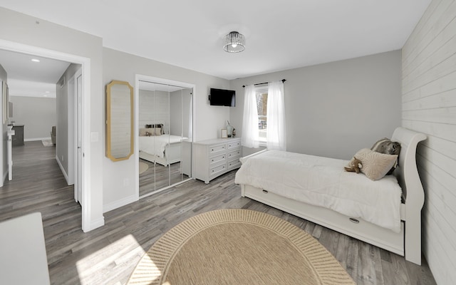 bedroom with light wood finished floors and baseboards