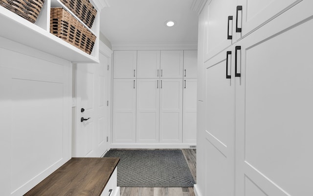 mudroom with recessed lighting, dark wood-style flooring, visible vents, and crown molding