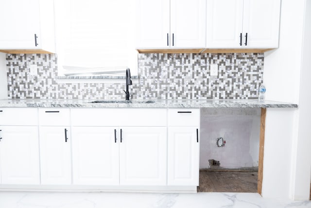 interior space with a sink and marble finish floor
