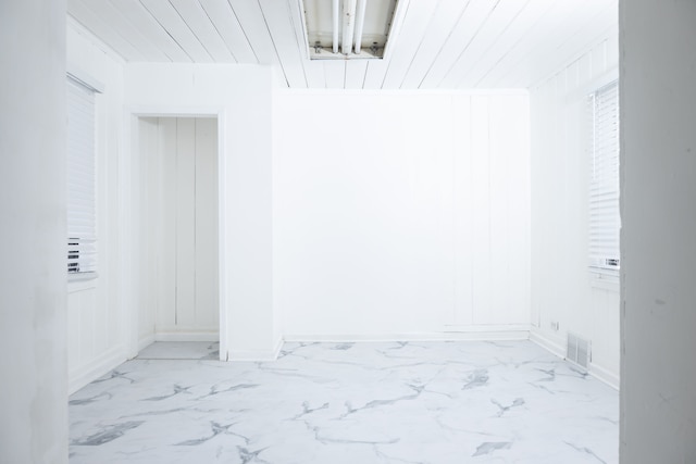 interior space featuring baseboards, visible vents, and marble finish floor