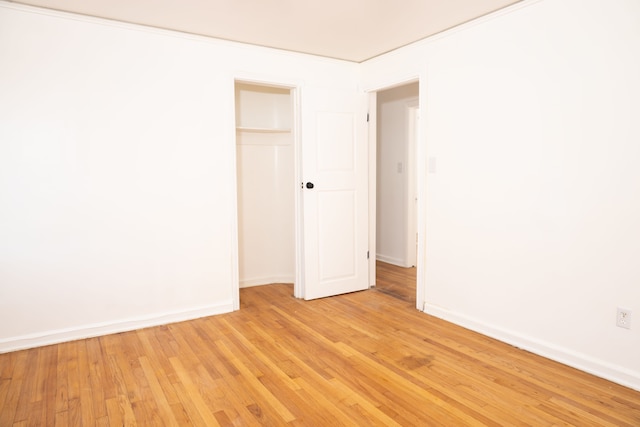 empty room with baseboards and light wood-style floors