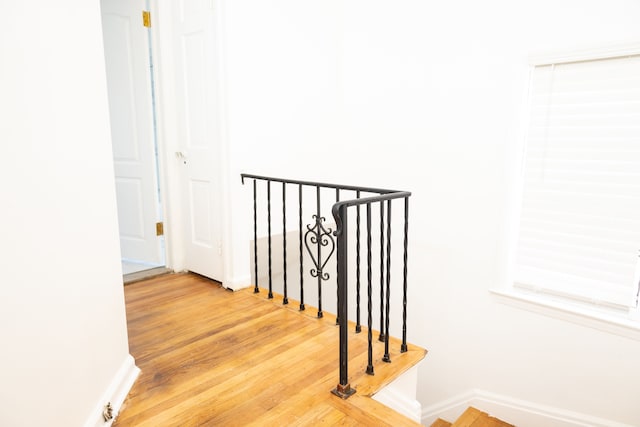 stairs with baseboards and wood finished floors