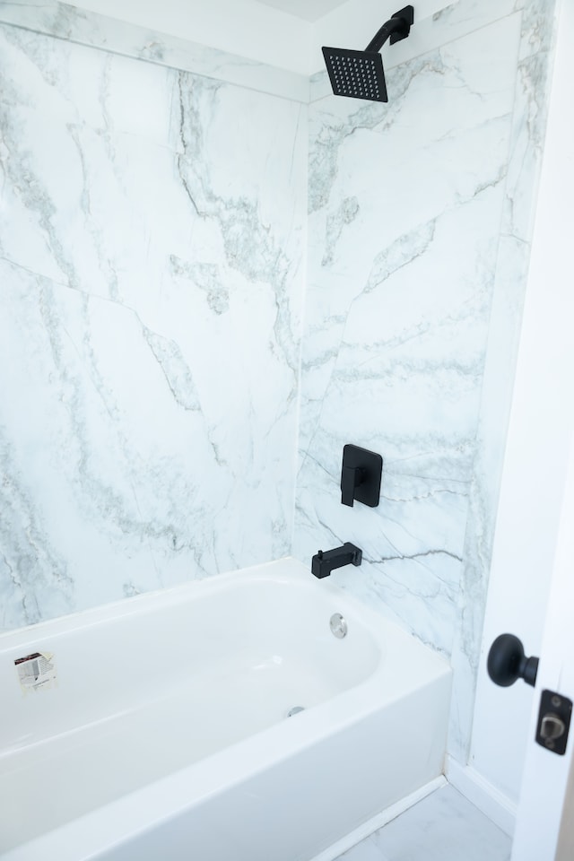 full bath with a shower, a tub to relax in, and marble finish floor