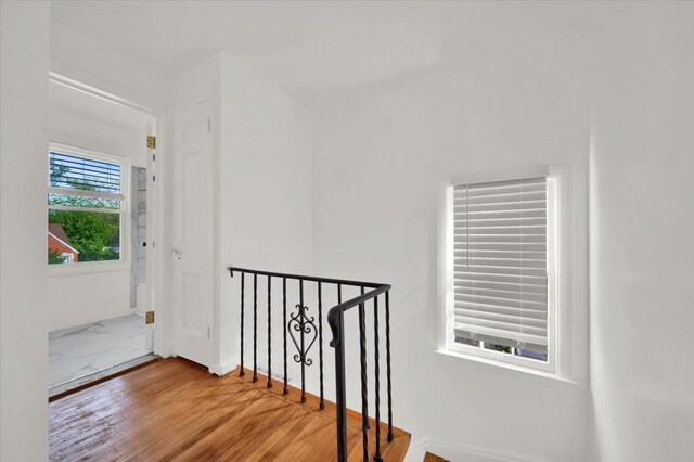 interior space with an upstairs landing and wood finished floors
