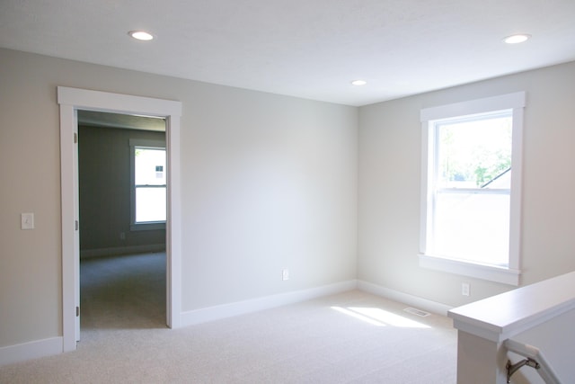 unfurnished room with light colored carpet