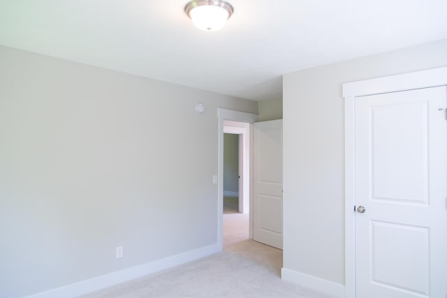 unfurnished bedroom with light colored carpet