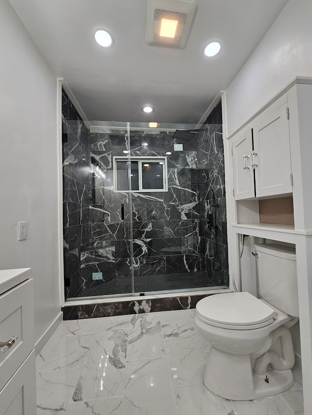 bathroom with vanity, a tile shower, and toilet