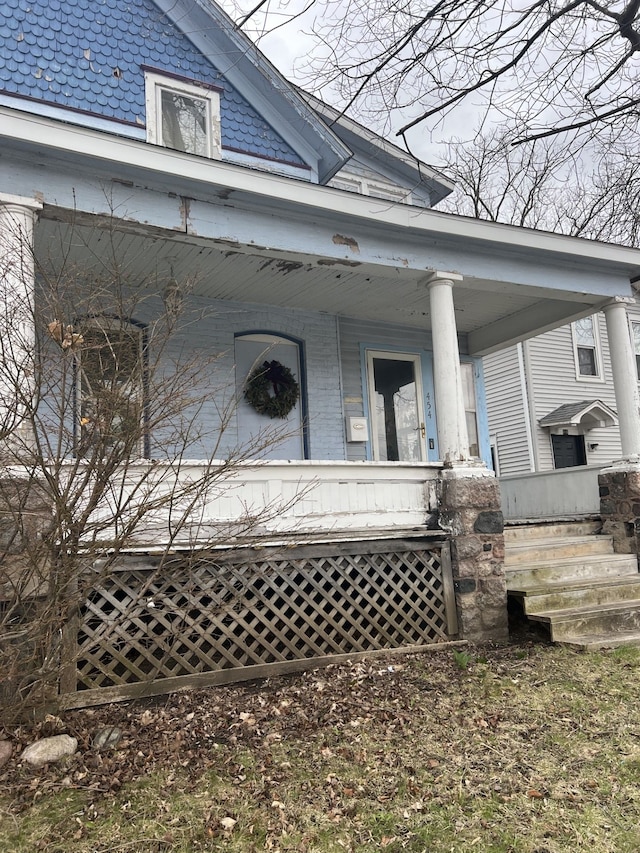 view of exterior entry featuring a porch