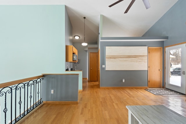 14113 Grandview Dr, Cement City, MI 49233 - foyer featuring baseboards, light wood-type flooring, a ceiling fan, and high vaulted ceiling