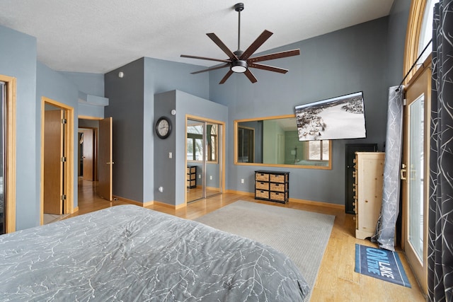 14113 Grandview Dr, Cement City, MI 49233 - bedroom with baseboards, wood finished floors, high vaulted ceiling, and ceiling fan