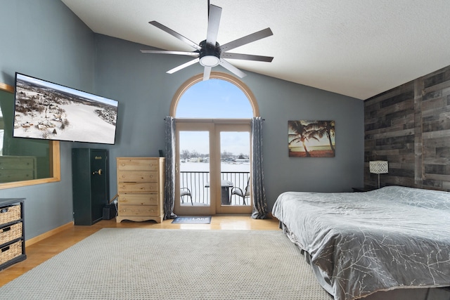 14113 Grandview Dr, Cement City, MI 49233 - bedroom featuring lofted ceiling, wood finished floors, baseboards, access to outside, and ceiling fan