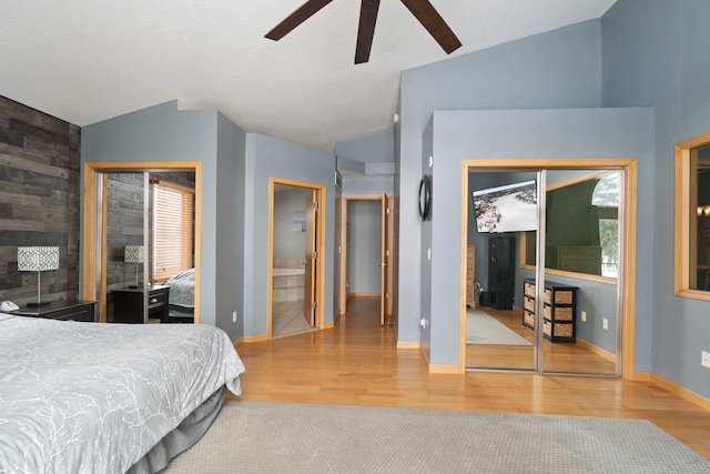 14113 Grandview Dr, Cement City, MI 49233 - bedroom featuring lofted ceiling, baseboards, wood finished floors, and multiple windows
