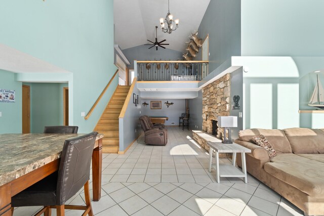14113 Grandview Dr, Cement City, MI 49233 - living area featuring stairs, high vaulted ceiling, a chandelier, and light tile patterned flooring