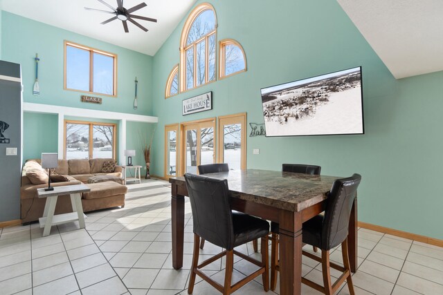 14113 Grandview Dr, Cement City, MI 49233 - dining area with high vaulted ceiling, baseboards, a ceiling fan, and light tile patterned floors