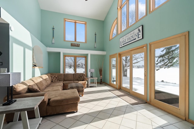 14113 Grandview Dr, Cement City, MI 49233 - living area with plenty of natural light, high vaulted ceiling, and light tile patterned floors