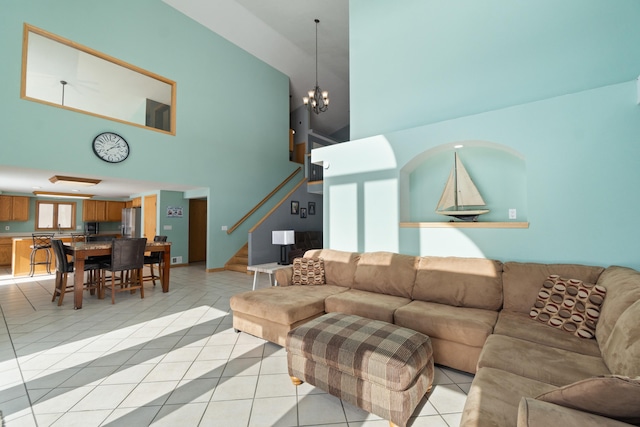 14113 Grandview Dr, Cement City, MI 49233 - living room featuring a chandelier, a towering ceiling, stairs, and light tile patterned floors