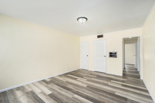 unfurnished room featuring dark wood-type flooring