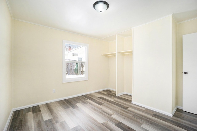 interior space featuring hardwood / wood-style flooring, a closet, and ornamental molding