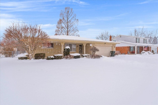 single story home featuring an attached garage and brick siding