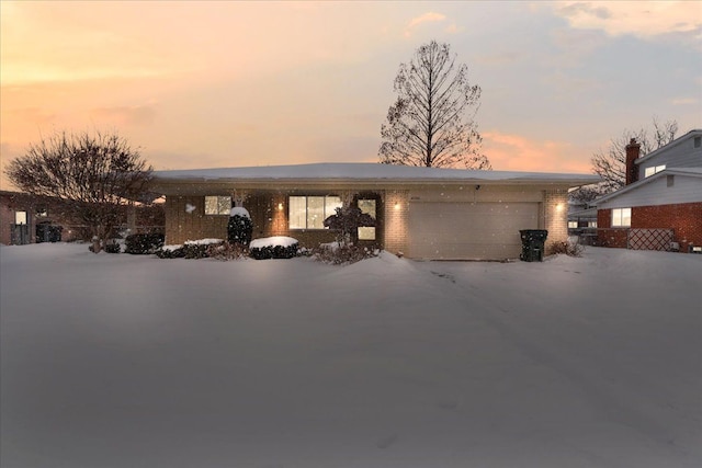 view of front of property with a garage and brick siding