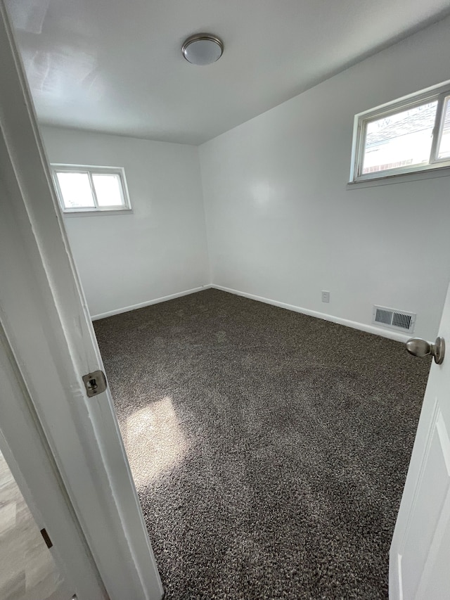 unfurnished room featuring carpet