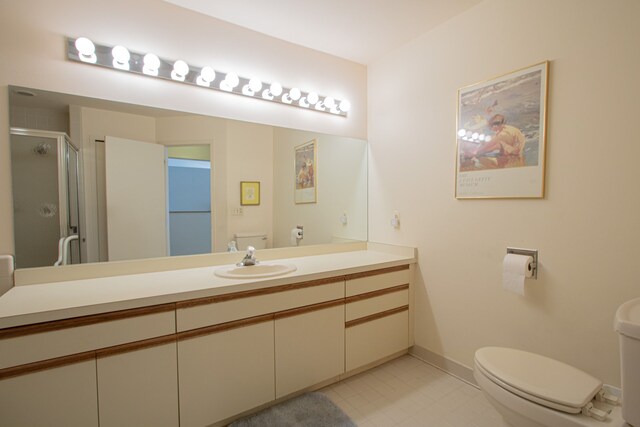 bathroom featuring toilet, vanity, and walk in shower