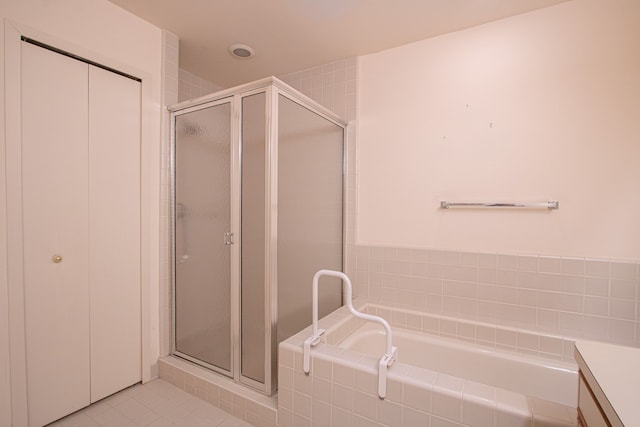 bathroom with a shower with shower door, tile patterned flooring, and vanity