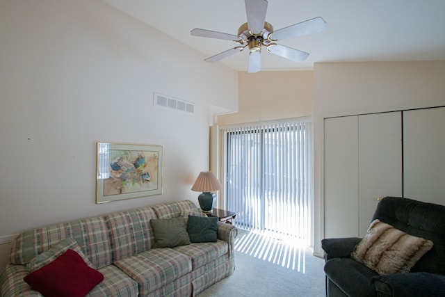 living room featuring lofted ceiling, ceiling fan, and carpet flooring