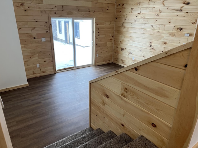 interior space featuring hardwood / wood-style floors and wooden walls