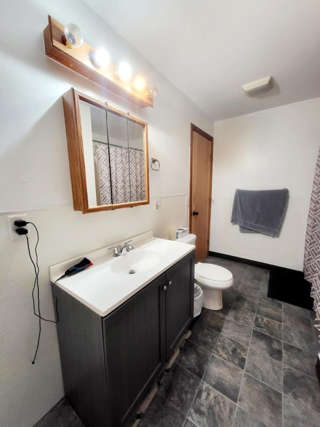full bathroom featuring toilet and vanity