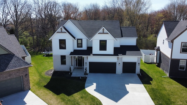 modern farmhouse with a front yard and a garage