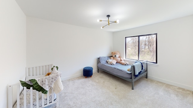 carpeted bedroom with a notable chandelier