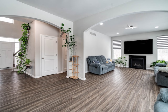 living area with plenty of natural light, visible vents, and dark wood finished floors