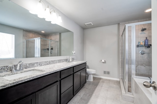 bathroom featuring toilet, a sink, visible vents, and a shower stall