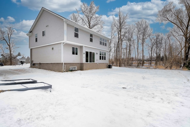 view of snow covered back of property