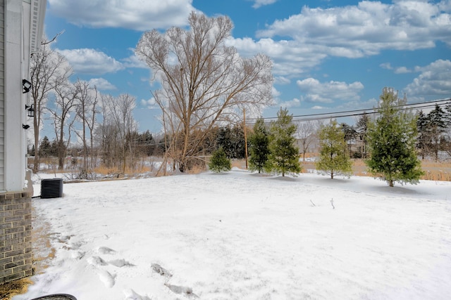 snowy yard featuring cooling unit