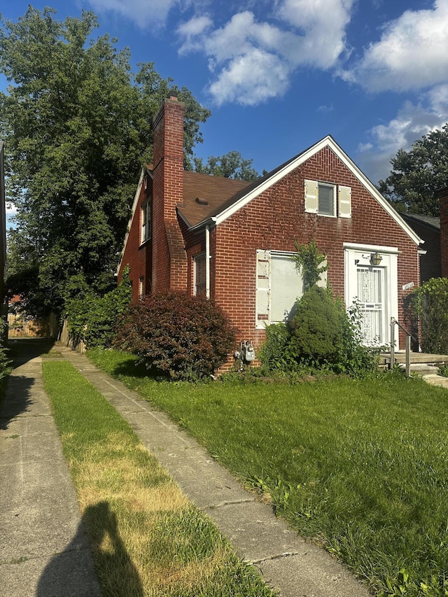 view of side of home with a lawn