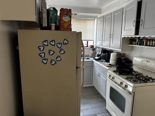 18658 Rutherford St, Detroit, MI 48235 - kitchen featuring white appliances, white cabinets, and backsplash