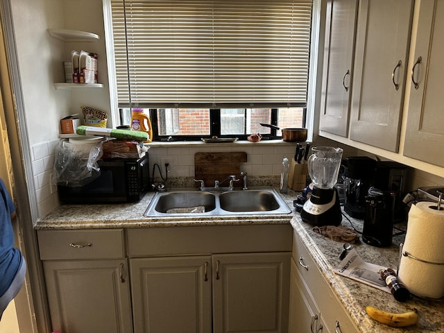 18658 Rutherford St, Detroit, MI 48235 - kitchen featuring sink and tasteful backsplash