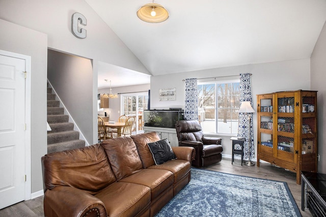 living room with lofted ceiling, dark hardwood / wood-style floors, and a wealth of natural light