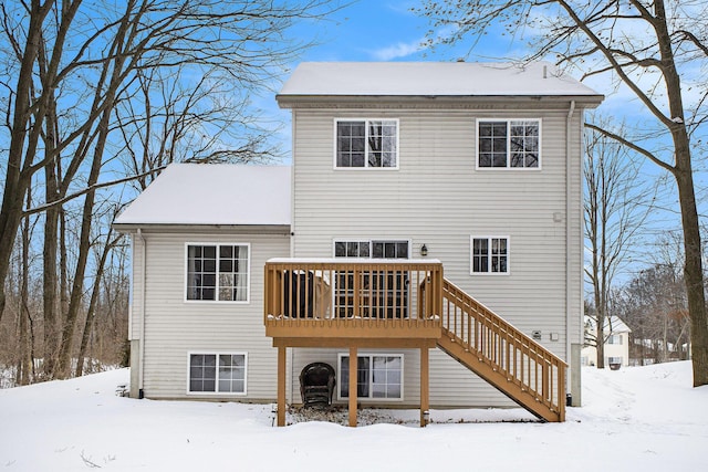 snow covered property with a wooden deck