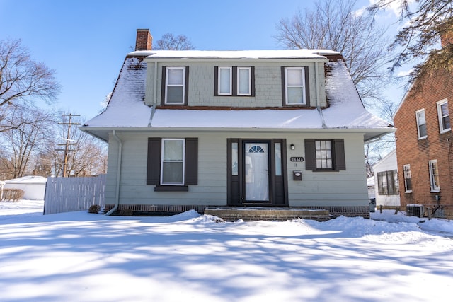 view of front of home featuring a chimney, central air condition unit, and fence